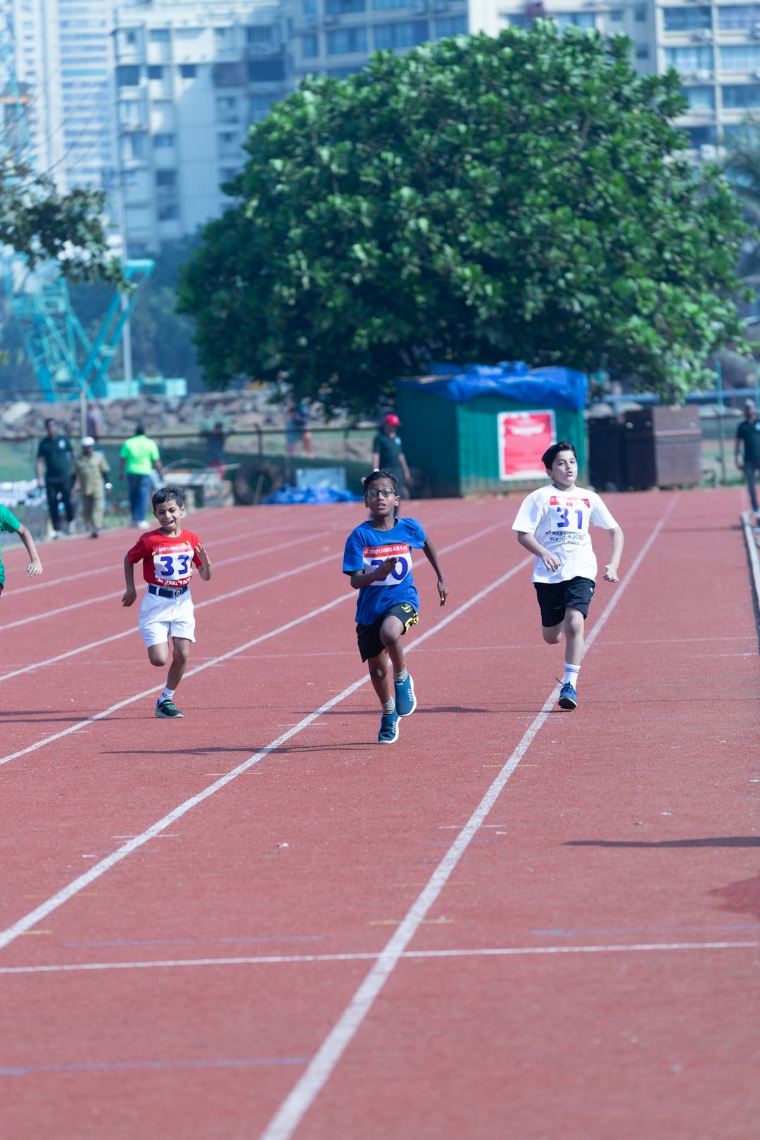 a-group-of-children-running-on-a-track-3p9hys86aag