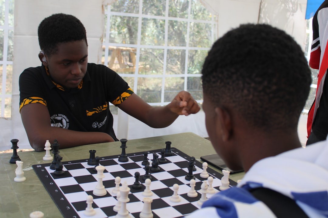 a-young-man-playing-chess-with-another-young-man-28xmes41stm